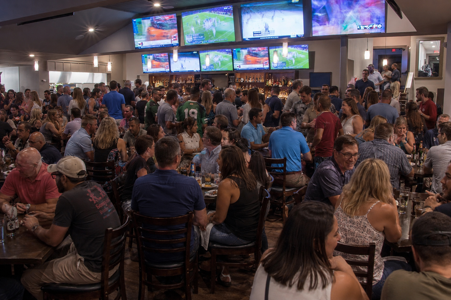 A crowded main dining room and sports bar at The Greenery